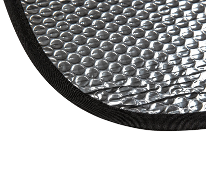 Close-up of a textured silver mat with black border on a white background
